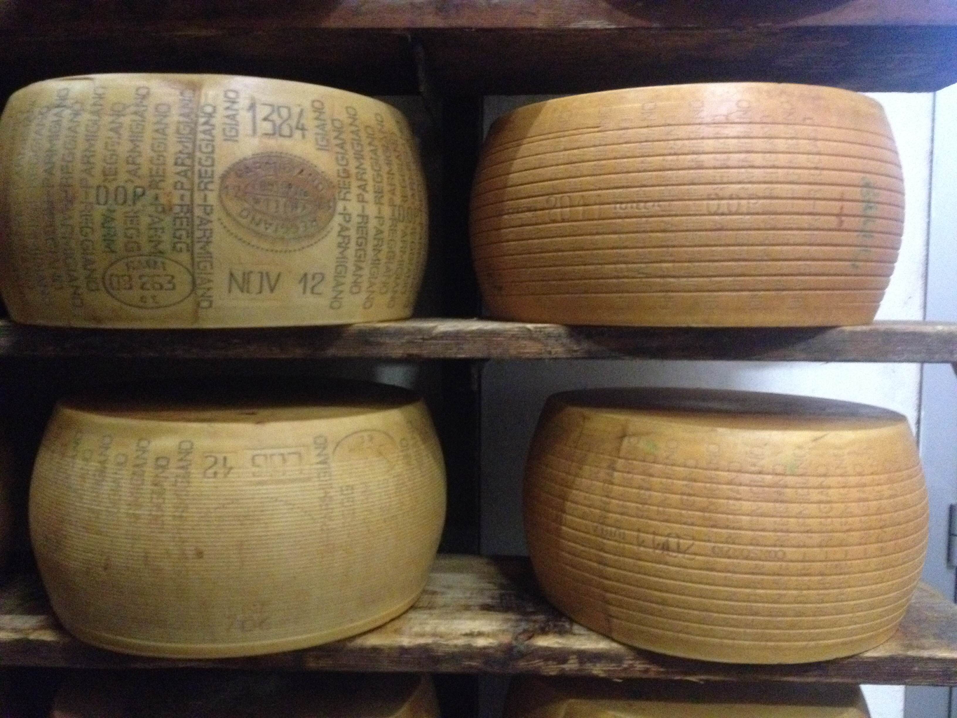 Four_Parmigiano-Reggiano_wheels_with_classifications.JPG
